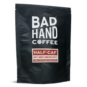 Two fifty gramme postal  bag of Half-Caf, low caffeine session coffee - taste notes: soft, sweet and biscuity. Roasted fresh to order from Bad Hand. Available as whole bean or ground to your home brew method. These bags are 100% paper and home compostable. 