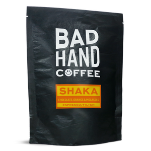 Two fifty gramme postal bag of Shaka, our house espresso filter blend - taste notes: chocolate, orange and molasses. Roasted fresh to order from Bad Hand Coffee. Available as whole bean or ground to your brew method. These bags are 100% paper and home compostable.