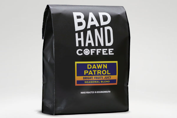 Bad Hand Coffee - One kilogram bag of Dawn Patrol, a seasonal blend - taste notes: bright, fruity, juicy. Hand roasted fresh to order. Available as whole bean or ground to your brew method. These bags are 100% paper and home compostable.