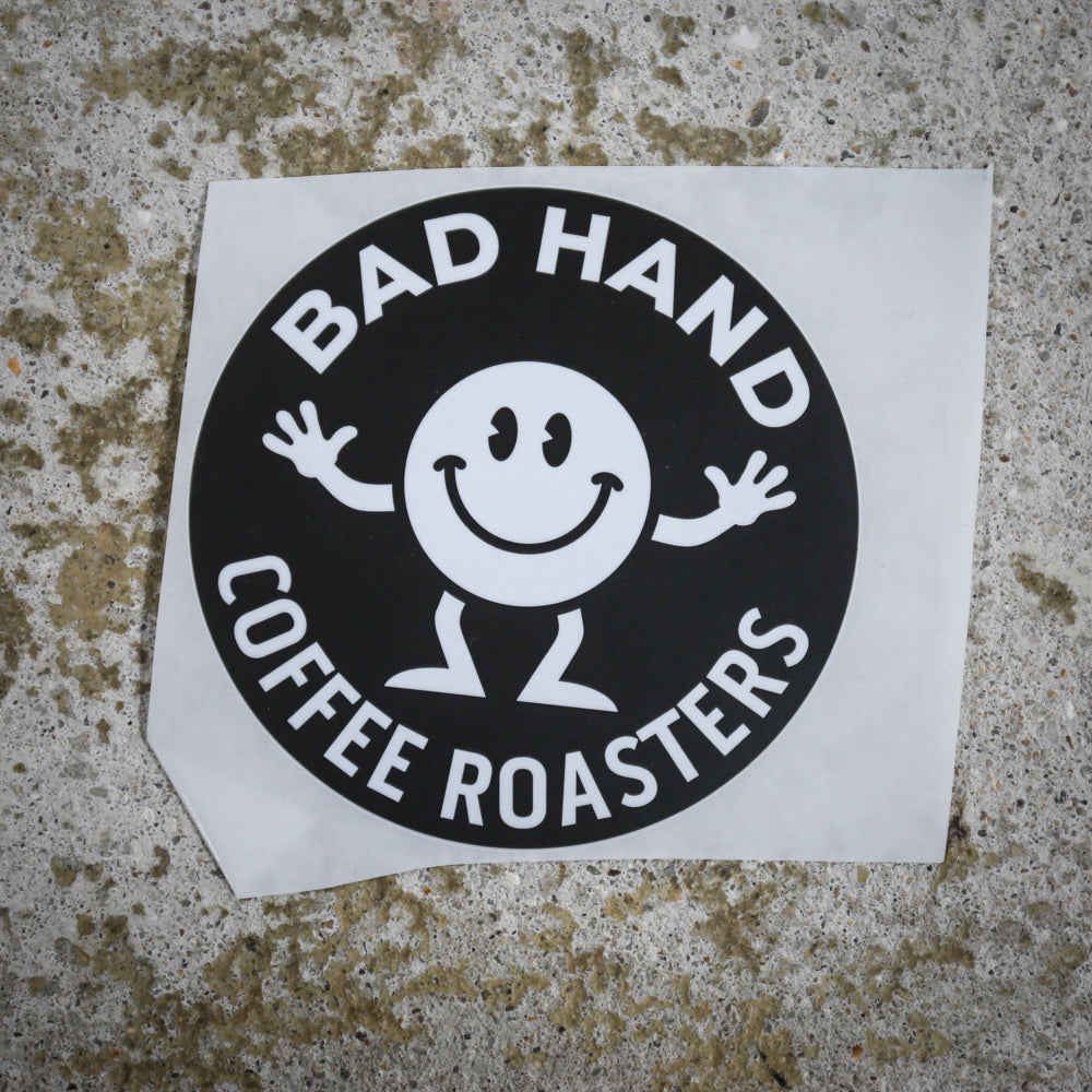 Bad Hand Coffee sticker pack, contains five waterproof stickers of various styles. Sticker one, round, with white text on a black background.