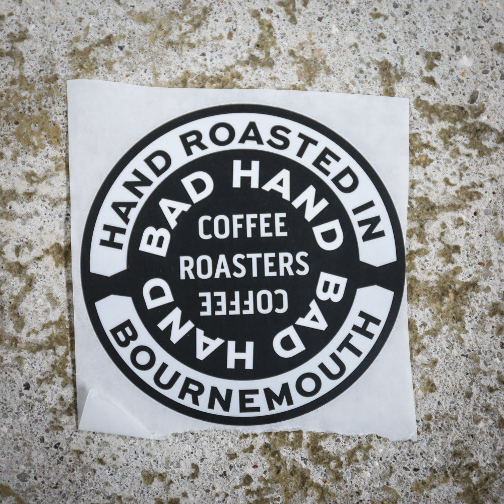 Bad Hand Coffee sticker pack, contains five waterproof stickers of various styles. Sticker three, round, with white text on a black background.